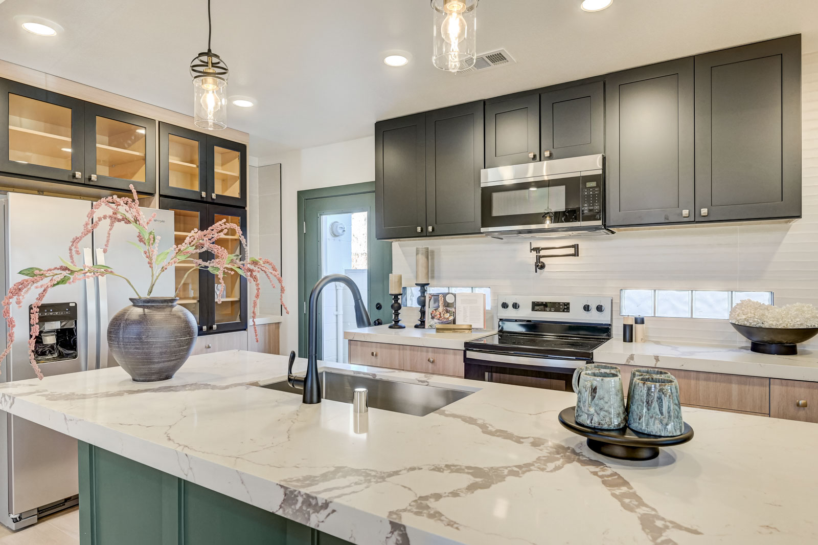 Kitchen island with quartz countertop and pendant lighting