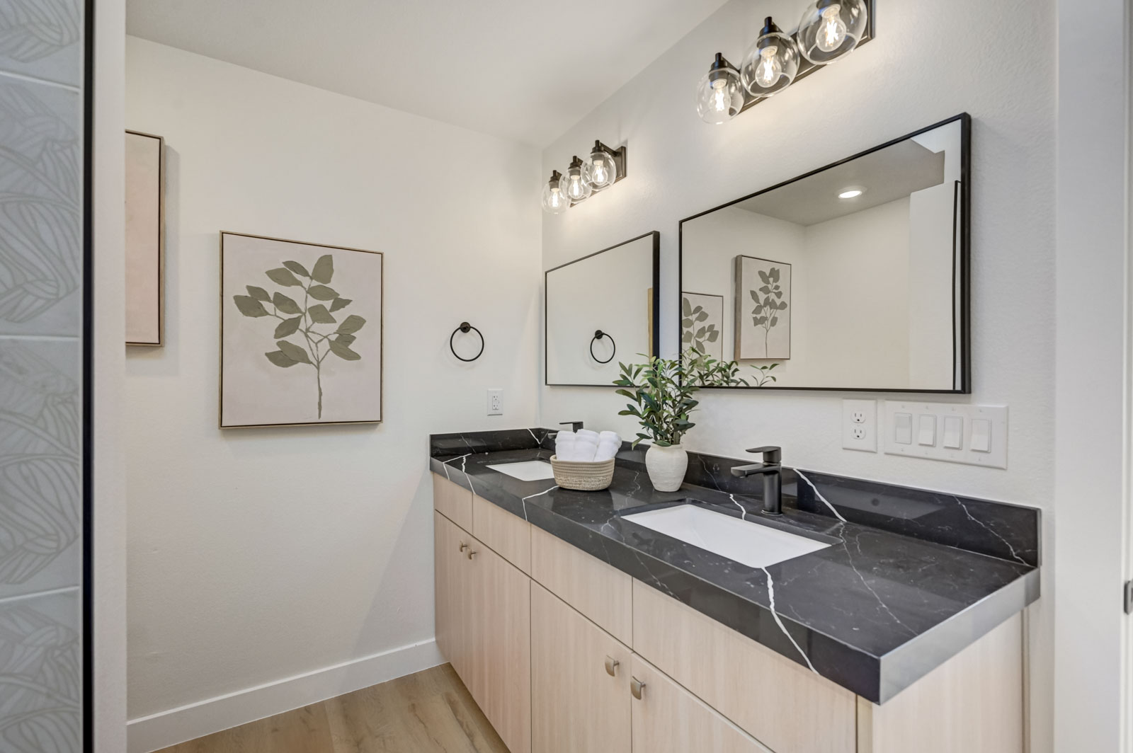 Primary bathroom with black marble double vanity